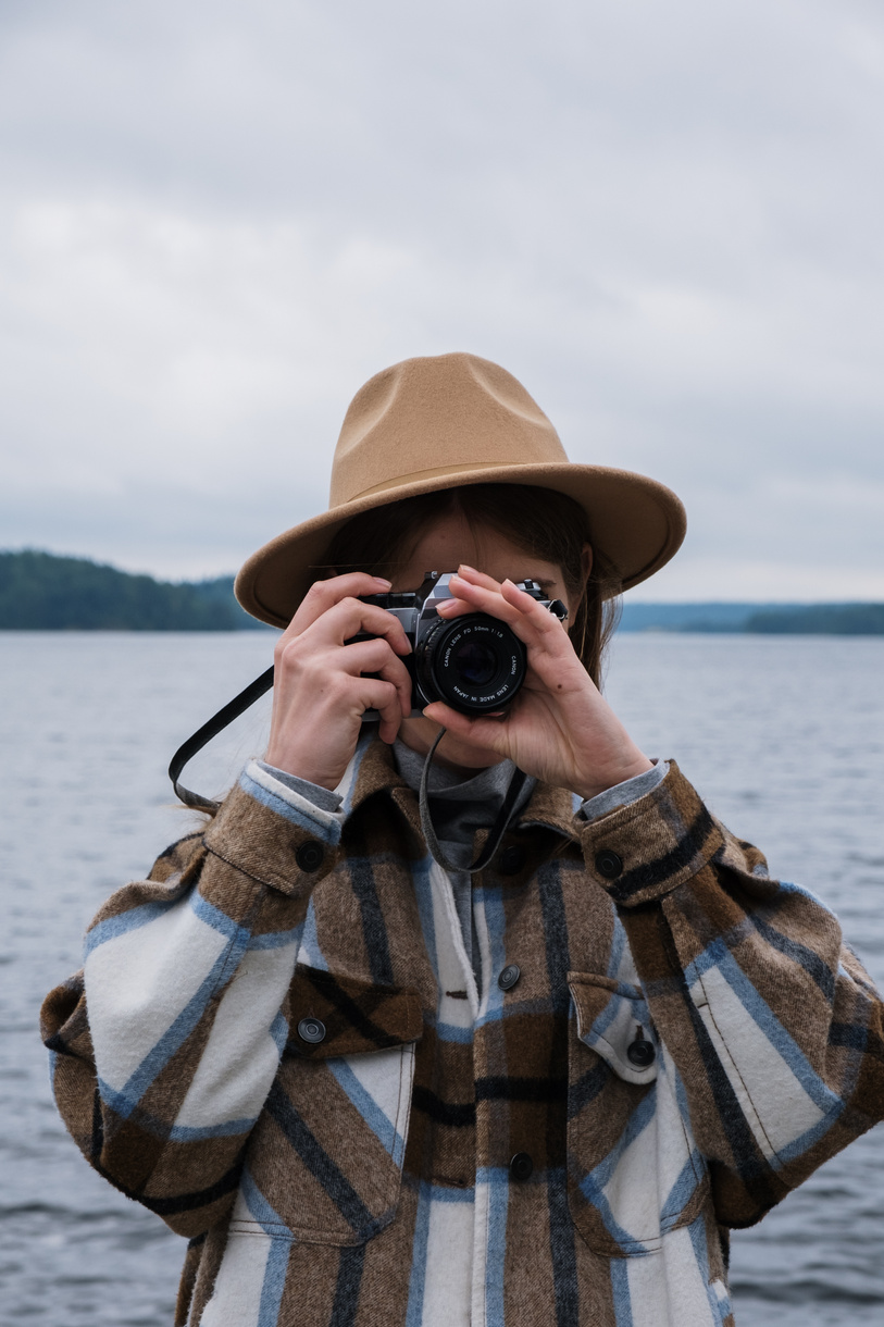 Person Wearing a Brown Hat Taking a Picture